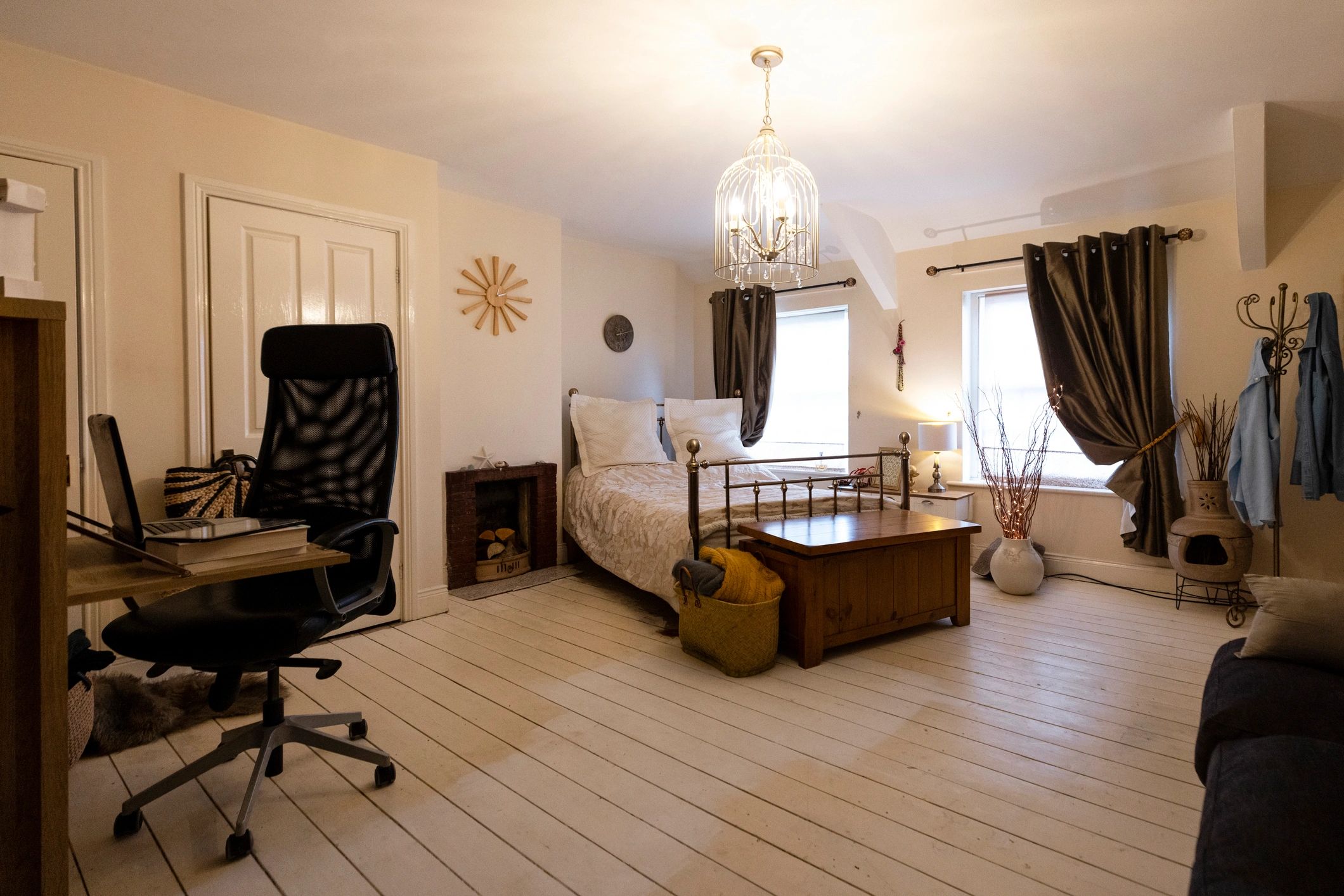 Renovated bedroom interior with warm lighting and layered textures
